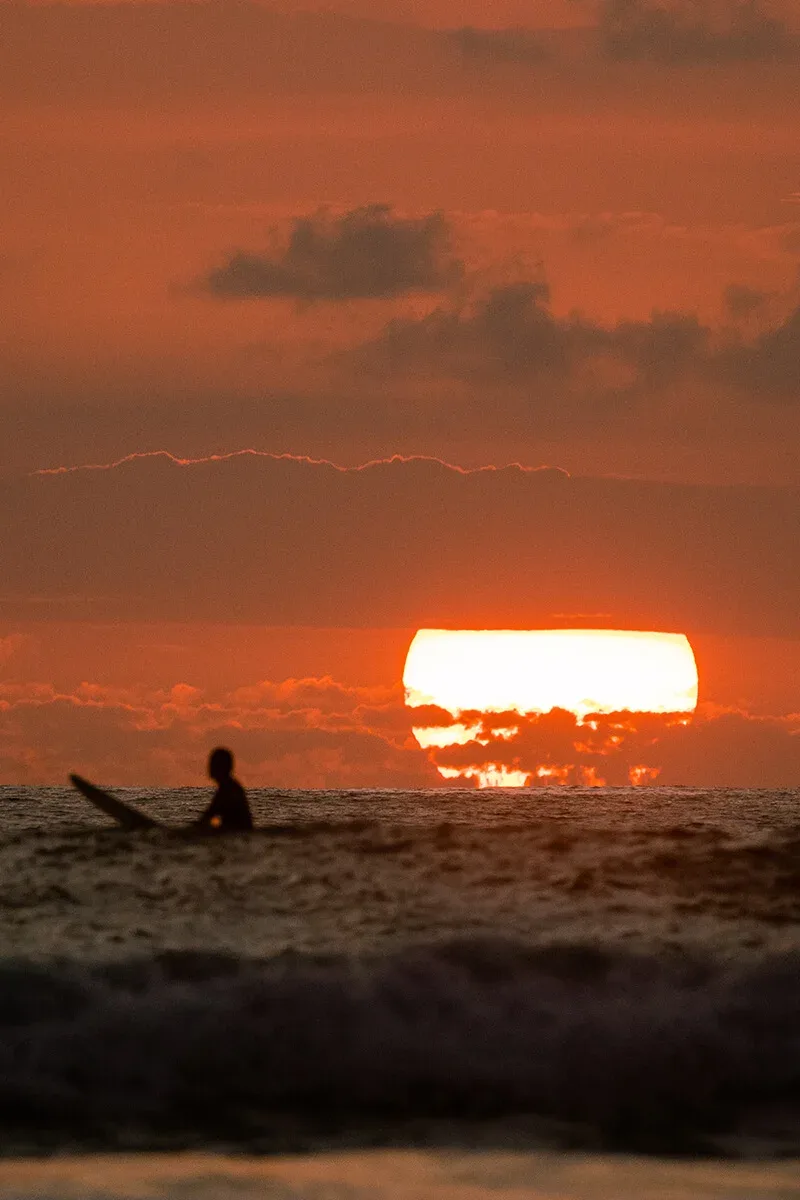 Surfer at sunset in Santa Teresa